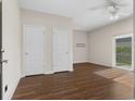 Spacious bedroom features wood-look flooring, neutral walls, ceiling fan, and sliding glass door leading to the exterior at 159 Terracina Circle, Myrtle Beach, SC 29588