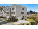 Two-story home with grey siding, black shutters, an attached garage, and green lawn at 159 Terracina Circle, Myrtle Beach, SC 29588