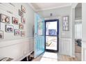 Bright foyer featuring a blue front door, stylish decor, and wood flooring at 161 Copper Leaf Dr., Myrtle Beach, SC 29588