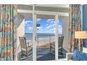 Balcony view with ocean view and rocking chairs, perfect spot for relaxing and enjoying the scenery at 161 Seawatch Dr. # 808, Myrtle Beach, SC 29572