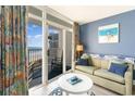 Inviting living room with balcony access, comfortable sofa and chairs, plus stylish coastal-themed decor at 161 Seawatch Dr. # 808, Myrtle Beach, SC 29572