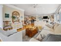 Bright, open-concept living room with hardwood floors and comfortable seating, flowing into dining and kitchen areas at 165 Marsh Lake Dr. # 27, Georgetown, SC 29440