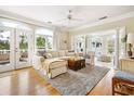 Comfortable living room featuring hardwood floors, a cozy sofa, and views of the outdoor greenery at 165 Marsh Lake Dr. # 27, Georgetown, SC 29440
