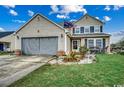 Inviting two-story home with a manicured lawn, a two-car garage, and an American flag at 177 Tibton Circle, Myrtle Beach, SC 29588