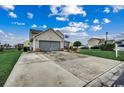 Two-story home featuring a two-car garage, American flag, and a long driveway at 177 Tibton Circle, Myrtle Beach, SC 29588