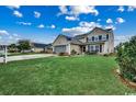 Expansive front lawn leading to a two-story home with a spacious two-car garage at 177 Tibton Circle, Myrtle Beach, SC 29588
