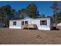 Well maintained gray single Gathering home with black shutters and wooden front deck at 2016 Misty Morning Dr., Conway, SC 29527