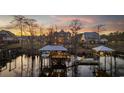 Scenic waterfront property featuring boat docks and a cozy outdoor seating area, surrounded by serene water and natural beauty at 208 Wahee Pl., Conway, SC 29527