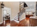 Elegant foyer featuring hardwood floors, a staircase with wrought iron railings, and views into the dining and living rooms at 208 Wahee Pl., Conway, SC 29527