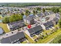 Aerial view showcases a community with a pond, pool, and well-maintained townhomes at 308 Golan Circle # A, Myrtle Beach, SC 29579