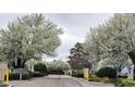 Picturesque neighborhood entrance, blossoming trees line the street of well maintained townhomes at 3700 Golf Colony Lane # 10C, Little River, SC 29566