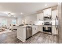 Modern kitchen with white cabinetry, stainless steel appliances, and an island at 395 S Crow Creek Dr. # 1704, Calabash, NC 28467