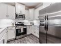 Kitchen featuring stainless steel appliances, sleek white countertops, and white cabinetry at 395 S Crow Creek Dr. # 1704, Calabash, NC 28467