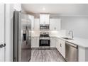 Stylish kitchen with stainless steel appliances and bright white cabinets at 395 S Crow Creek Dr. # 1709, Calabash, NC 28467