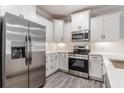Bright kitchen showcasing white cabinets and stainless steel appliances at 395 S Crow Creek Dr. # 1709, Calabash, NC 28467