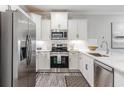 Bright kitchen with stainless steel appliances, white cabinetry, and modern countertops at 395 S Crow Creek Dr. # 1710, Calabash, NC 28467