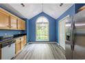 Bright kitchen features stainless appliances, wood cabinets, and a large window with a view at 409 65Th Ave. N, Myrtle Beach, SC 29572