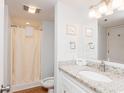 Cozy bathroom featuring a shower, granite vanity, and framed coastal art at 410 Melrose Pl. # 308, Myrtle Beach, SC 29572