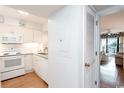 Efficient kitchen layout with white appliances and a pass-through window at 410 Melrose Pl. # 308, Myrtle Beach, SC 29572