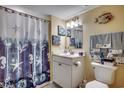 Well-lit bathroom featuring a white vanity, toilet, and a shower with a beach-themed curtain at 4103 N Ocean Blvd. # 304, North Myrtle Beach, SC 29582