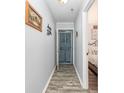 Hallway features wood-look flooring and neutral wall paint at 4350 Intercoastal Dr. # 1404, Little River, SC 29566