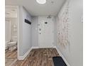 Welcoming unit entry with wood-look flooring, a coat rack and a convenient half bath nearby at 501 S Ocean Blvd. # 307, North Myrtle Beach, SC 29582