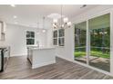 Open dining area with modern chandelier and sliding glass doors leading to an outdoor patio at 6031 Forest Dell Ct, Myrtle Beach, SC 29579