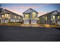 View of the two-story townhome with a dual garage, sidewalks, and manicured landscaping at 670 2Nd Ave. N, North Myrtle Beach, SC 29582