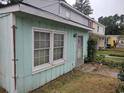 Side view of exterior with muted green siding, window, and exterior door, number 7 at 7 Century St. # 7, Myrtle Beach, SC 29577