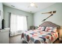 Cozy bedroom featuring a comfortable bed, bright window, and tasteful decor elements at 705 Beach Walk Pl. # 705, Myrtle Beach, SC 29577