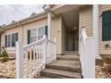 Welcoming entrance to townhouse with decorative rock landscaping, painted steps and crisp white railings at 705 Beach Walk Pl. # 705, Myrtle Beach, SC 29577