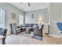 Comfortable living room with tile flooring, stylish furniture, and bright natural light from window at 705 Beach Walk Pl. # 705, Myrtle Beach, SC 29577