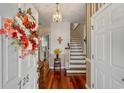 Inviting foyer with hardwood floors, staircase, and decorative wreath on the front door at 728 Elizabeth Dr., Murrells Inlet, SC 29576