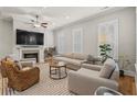 Bright living room with a fireplace, ceiling fan, and neutral-toned furniture at 7809 Monarch Dr., Myrtle Beach, SC 29572