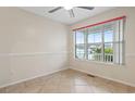 Bright bedroom featuring a ceiling fan and a large window offering pleasant neighborhood views at 810 Finger Lake Dr., Myrtle Beach, SC 29588