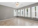 Serene bedroom featuring neutral walls, multiple windows with sheer curtains and tiled floors at 810 Finger Lake Dr., Myrtle Beach, SC 29588