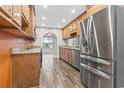 Well-lit kitchen featuring wood cabinets, stainless steel appliances, and wood-look flooring at 810 Finger Lake Dr., Myrtle Beach, SC 29588
