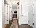 Inviting hallway with hardwood floors, leading to a cozy living room with fireplace at 909 Witherbee Way, Little River, SC 29566