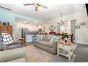 Open-concept living room with a sofa, ceiling fan and a view into the dining and kitchen areas at 909 Witherbee Way, Little River, SC 29566