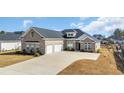Charming brick home featuring an extra wide driveway and a 2-car garage at 931 Henry James Dr., Myrtle Beach, SC 29579