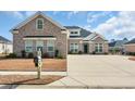 Attractive home with a well-maintained lawn and a long driveway at 931 Henry James Dr., Myrtle Beach, SC 29579
