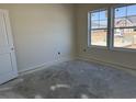 Well-lit bedroom features a double window, neutral walls, and clean lines, ready for personalization at 1013 Jase Dr., Longs, SC 29568