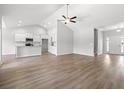 Spacious living room with hardwood floors, neutral walls, and a clear view into the kitchen area at 119 Old Chimney Ln, Conway, SC 29526