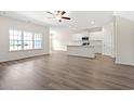 Bright open-concept living room with hardwood floors and large windows overlooking neighborhood at 127 Old Chimney Ln, Conway, SC 29526