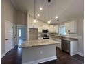 Open concept kitchen with stainless appliances, a center island, and an open layout at 130 Palm Dr., Loris, SC 29569