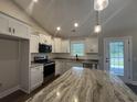 Modern kitchen with stainless steel appliances, gray countertops, and bright white cabinetry at 130 Palm Dr., Loris, SC 29569