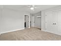 Bright bedroom featuring neutral carpet, a ceiling fan, and two closets with white doors at 1413 Crooked Hook Rd., North Myrtle Beach, SC 29582