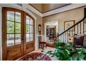 Welcoming foyer showcasing hardwood floors, elegant staircase, and stylish front door at 1539 Old Town Ave., Georgetown, SC 29440