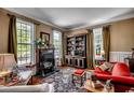 Cozy living room with fireplace, built-in shelves, and large windows at 1539 Old Town Ave., Georgetown, SC 29440