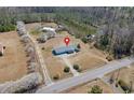 Aerial shot showcases the home's location on a spacious lot with mature trees and a long driveway at 1651 Circle Bay Dr., Longs, SC 29568